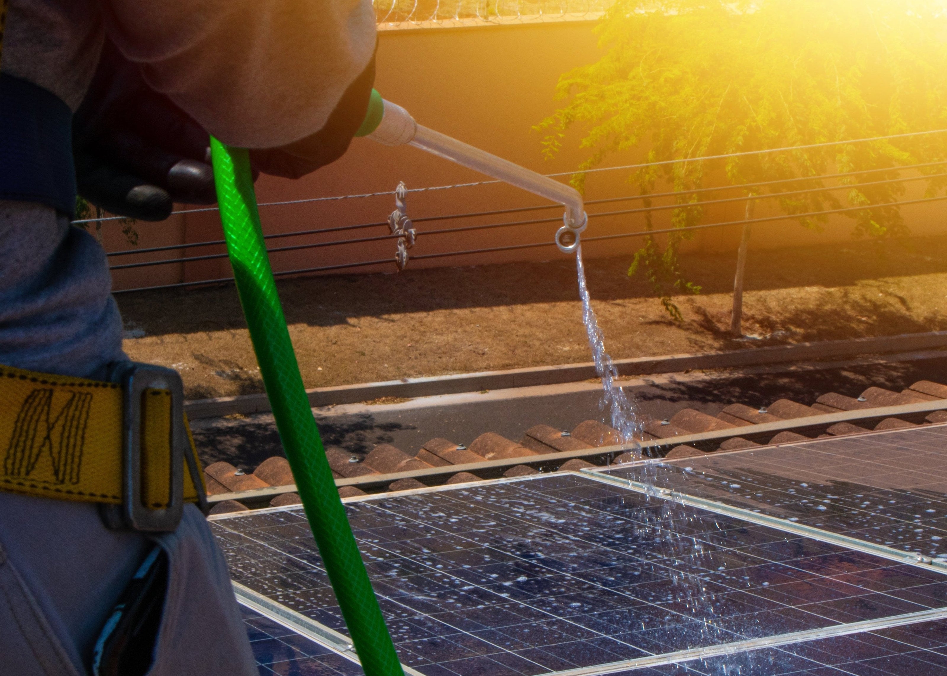 solar worker cleaning photovoltaic panels with brush water photovoltaic cleaning